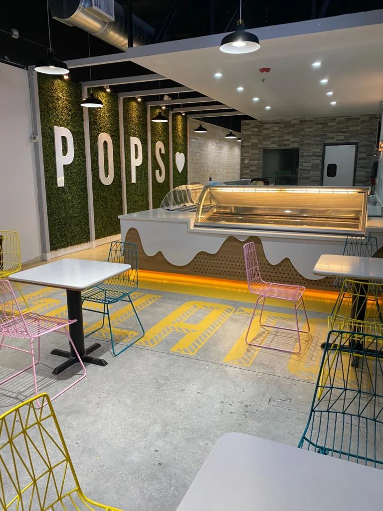 Modern restaurant interior at Alma Mia featuring custom design elements, ambient lighting, and branded environments by Habitar 91 in South Florida