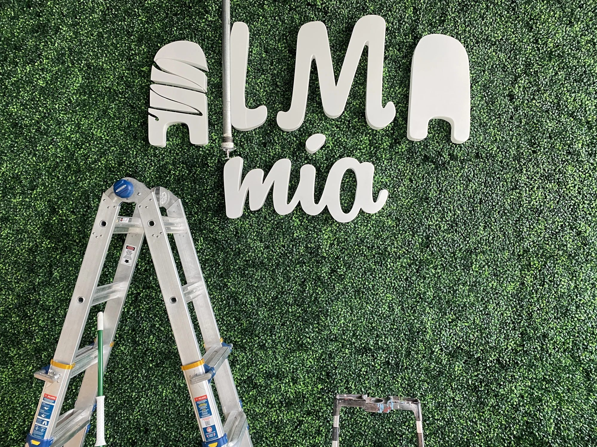 Modern restaurant interior at Alma Mia featuring custom design elements, ambient lighting, and branded environment created by Habitar 91 in South Florida