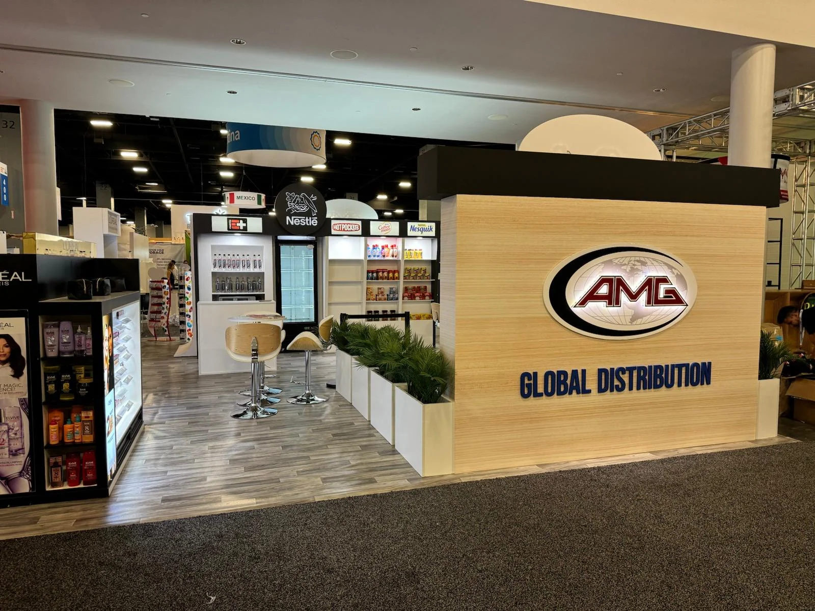 Professional trade show booth designed and built by Habitar 91 for AMG Global Distribution at a Miami, Florida event, featuring custom branding, signage, and display elements.