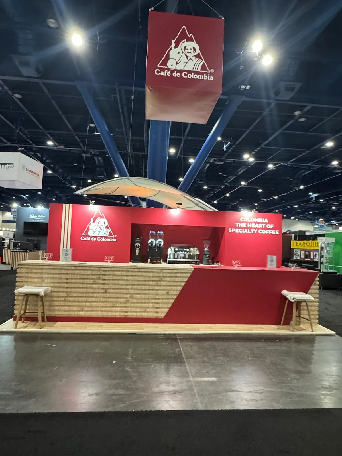 Custom trade show booth design and fabrication for Café de Colombia featuring branded graphics and display elements in San Diego