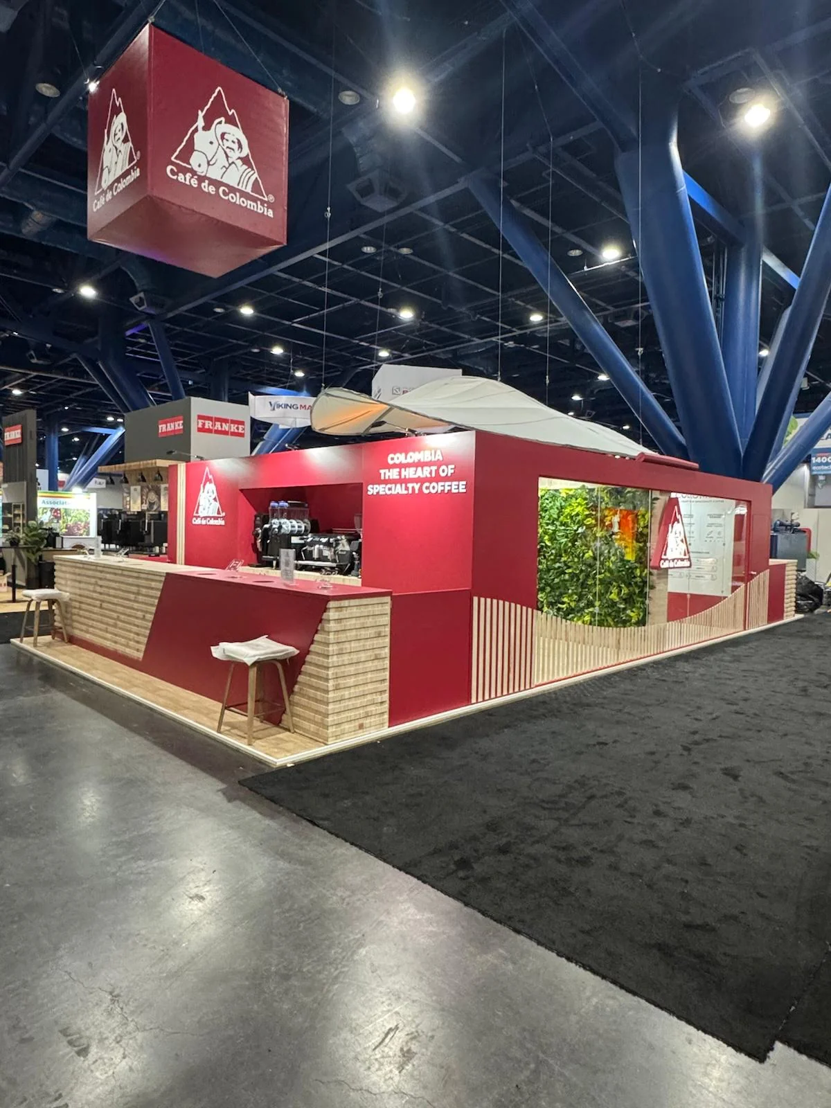 Custom trade show booth design and fabrication for Cafe de Colombia featuring branded environment and product display in San Diego