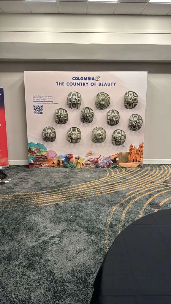 Custom fabric backdrop installation for Co Colombia exhibition, featuring branded design elements and professional staging by Habitar 91
