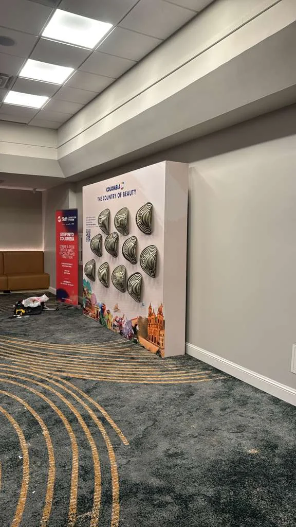 Custom fabric backdrop installation for Co Colombia exhibition featuring branded design and professional fabrication by Habitar 91