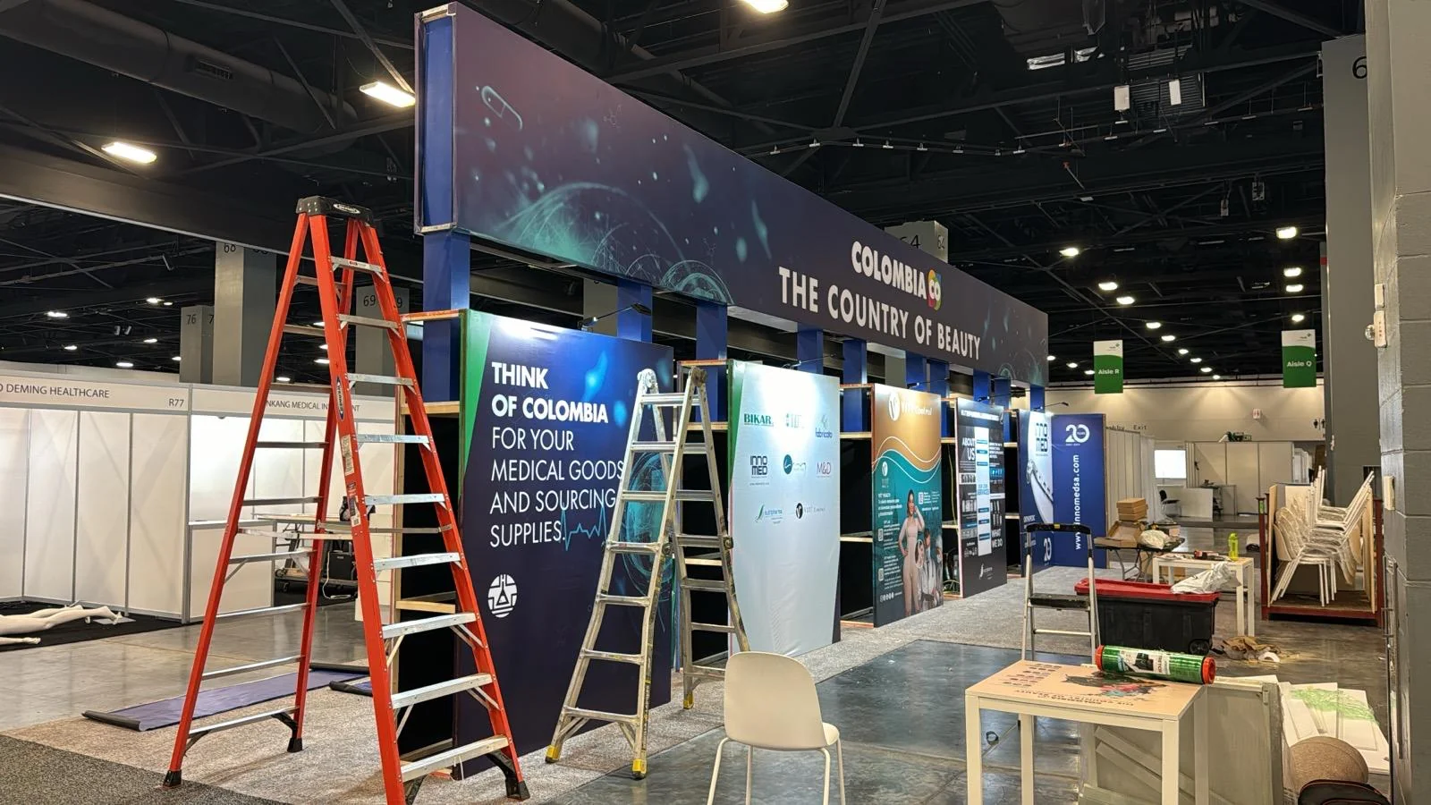 Professional trade show booth for Co Colombia featuring custom branding, modern design elements, and interactive display areas at Las Vegas event venue