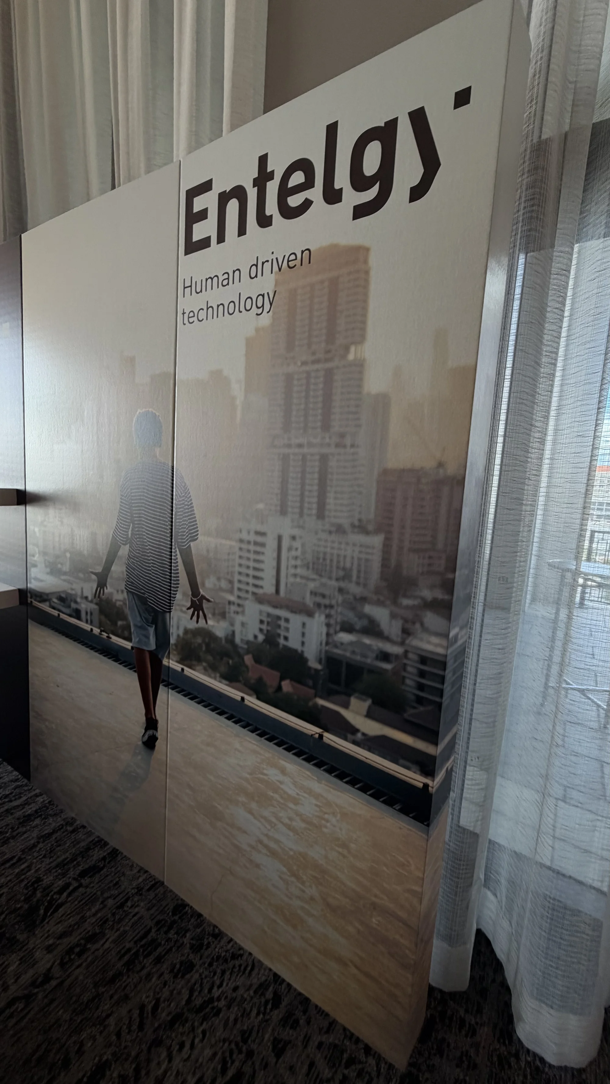 Custom cardboard backdrop installation for Entelgy brand activation event, featuring structural design and branded messaging