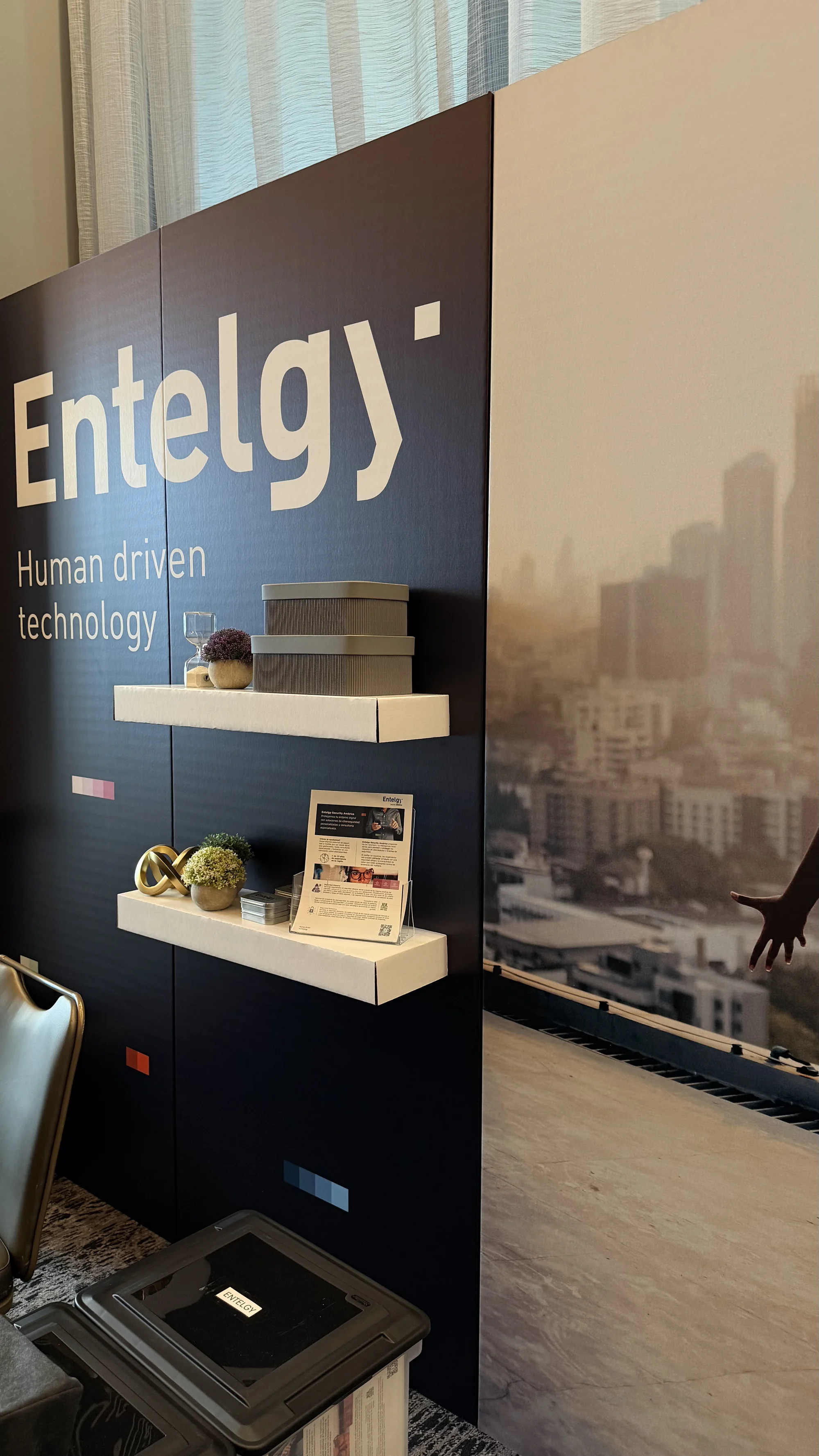 Custom cardboard backdrop display for Entelgy brand activation event, featuring sustainable material construction and branded design elements