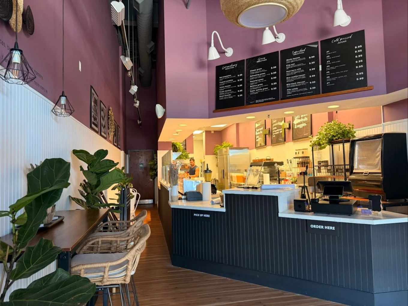 Modern juice bar interior with custom branding, counter design, and wall graphics at Maraneros Juice Bar in Davie, Florida, designed and built by Habitar 91